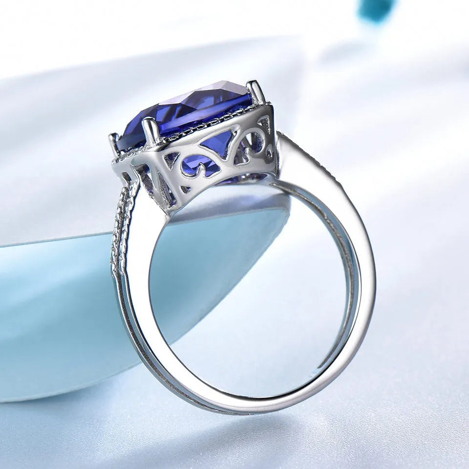 Women's sterling silver ring with a deep blue tanzanite gemstone.