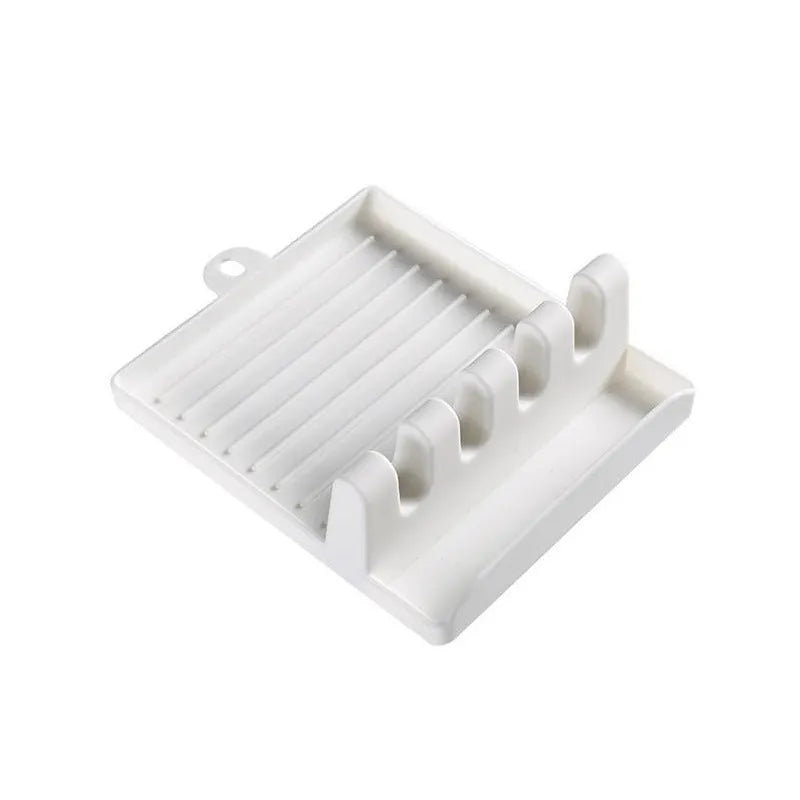 Green silicone 4-hole kitchen spatula holder with chopsticks and spoon on clean countertop