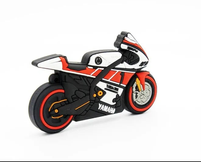 Cartoon motorcycle USB drive with red white wristband and key ring on a surface
