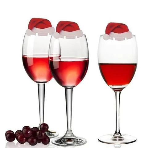 10 red paper Santa hat wine glass toppers on a Christmas table