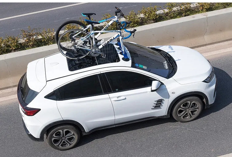Bicycle suction cup roof rack made of aluminium alloy and rubber in red and black on a car roof