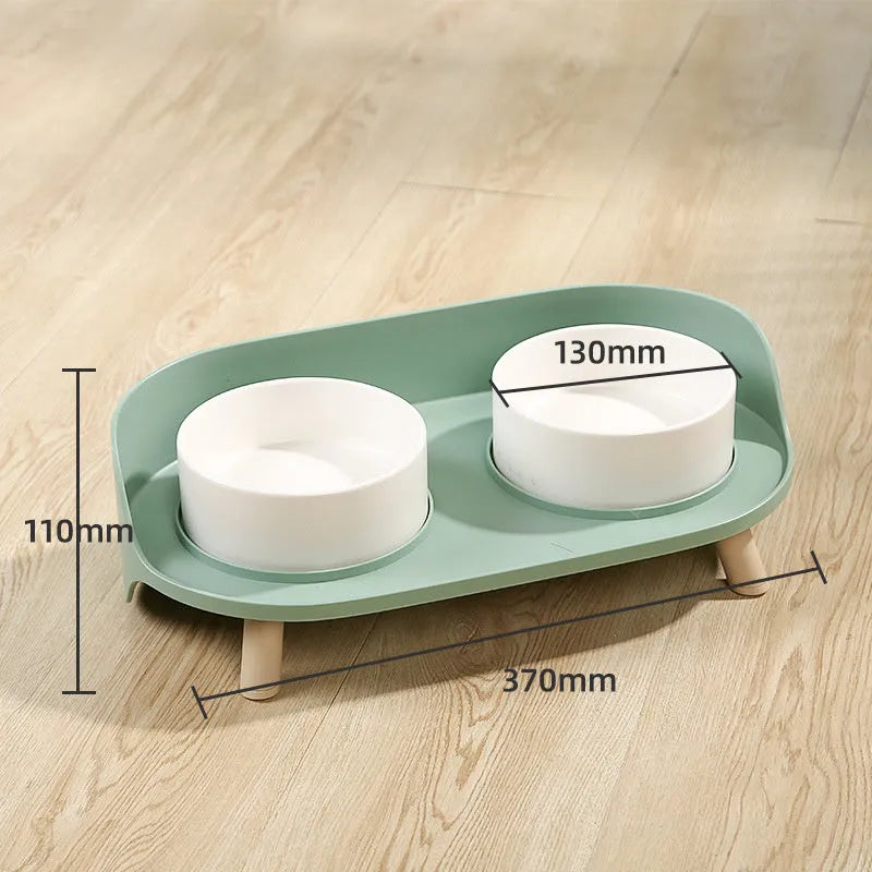 Green and white adjustable tilted pet feeding bowl with dual food and water compartments for cats and dogs