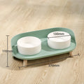 Green and white adjustable tilted pet feeding bowl with dual food and water compartments for cats and dogs