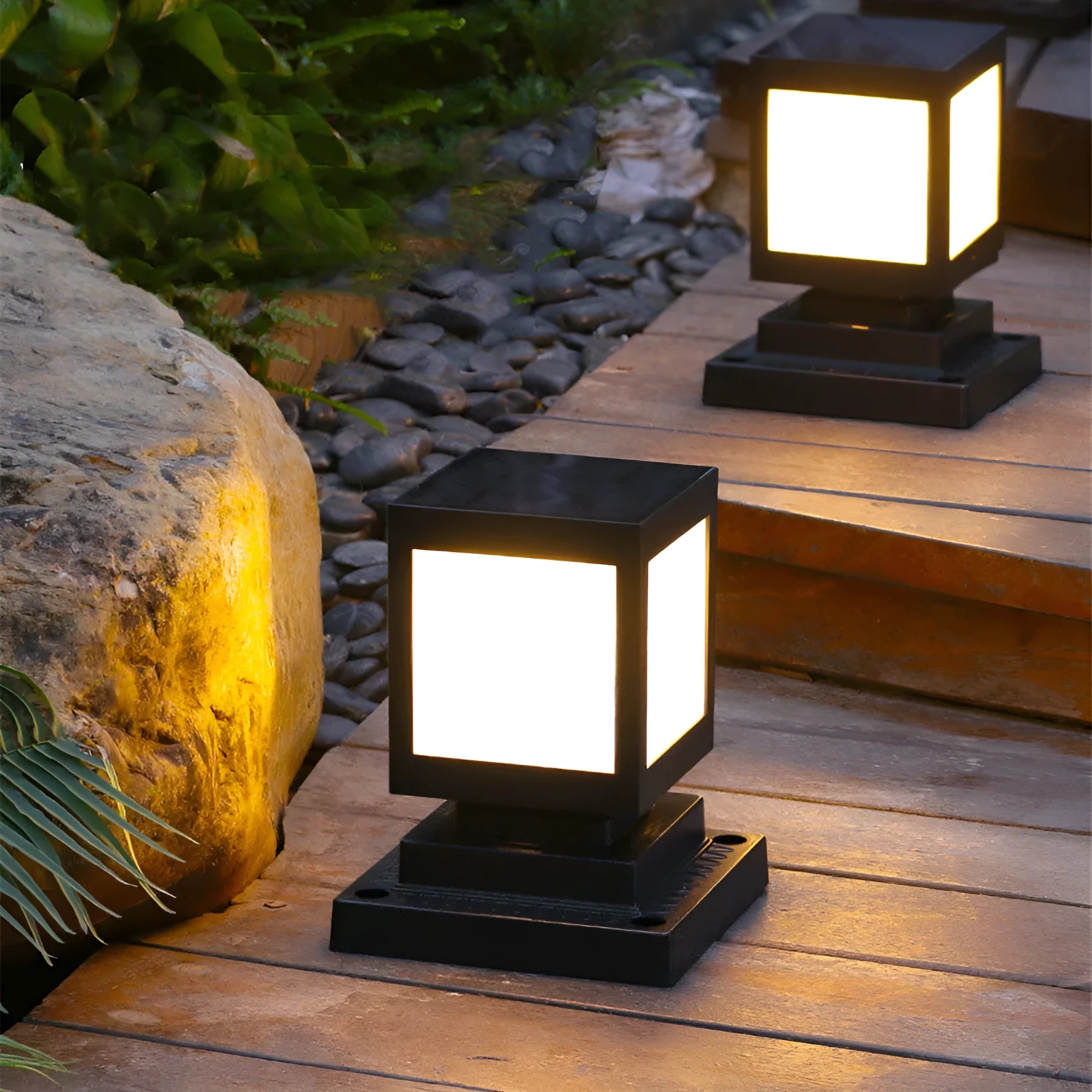 Set of solar-powered LED garden lights in different styles mounted on a garden wall and path