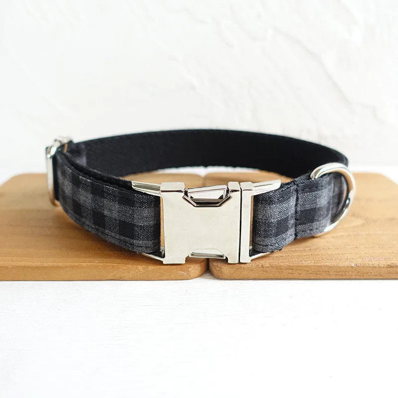 Black polyester dog training leash with metal chain ring on a plain background