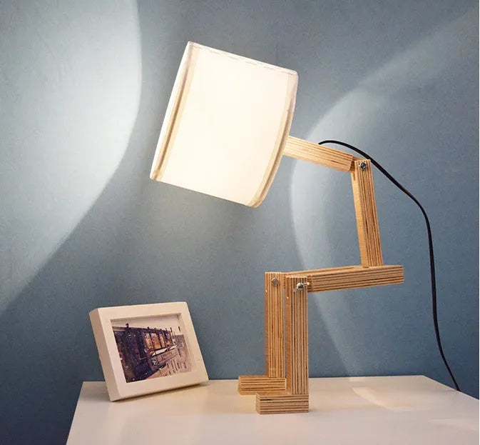 Creative wooden humanoid table lamp with white fabric shade on desk, 22x44x16 cm, button switch