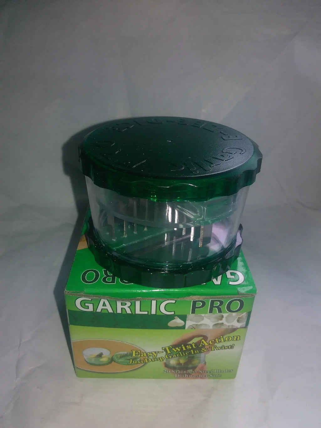 Green transparent PP plastic garlic peeler, 8.5 x 8.5 x 6 cm, on kitchen surface