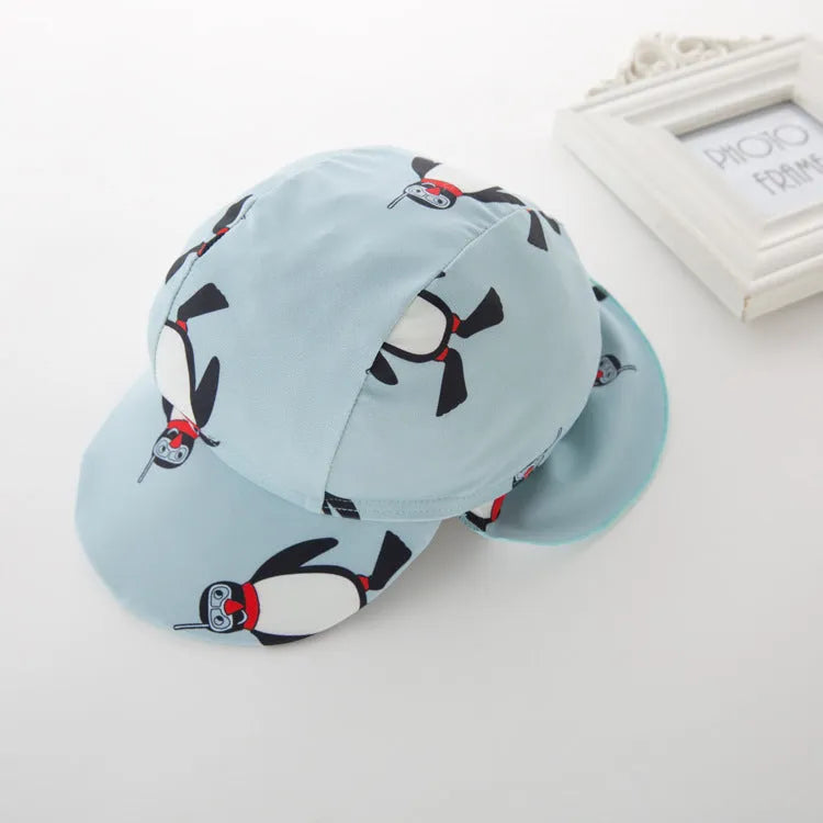 Boys' penguin print two-piece swim set with long sleeve rash guard top and matching swimming cap