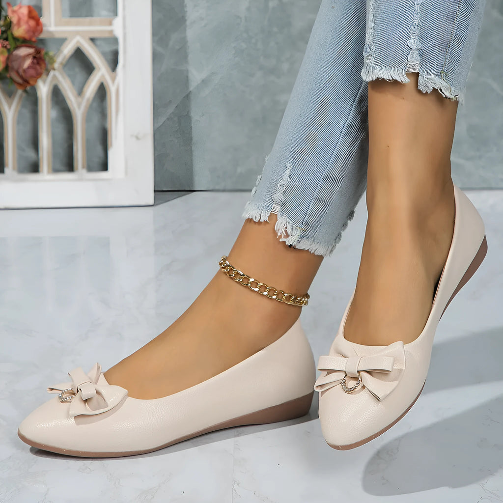 Women's beige casual flat shoes with a bowknot detail on the artificial PU upper.