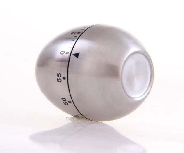 Stainless steel egg-shaped mechanical kitchen timer on countertop