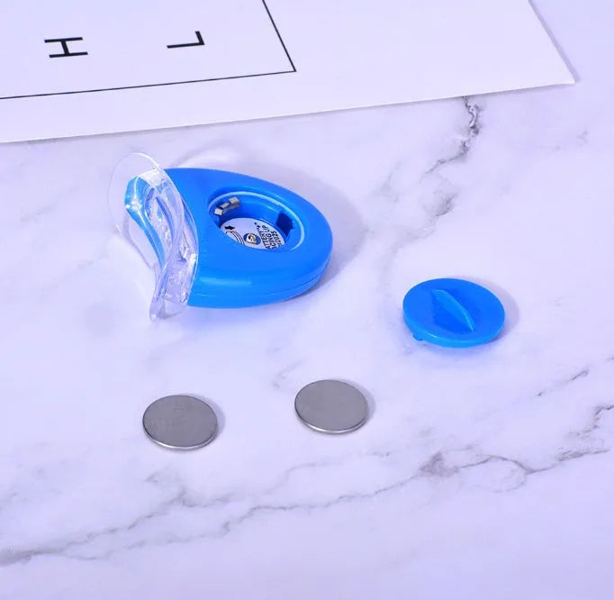 Teeth whitening kit with LED light and three 3ml gel sticks in blue packaging