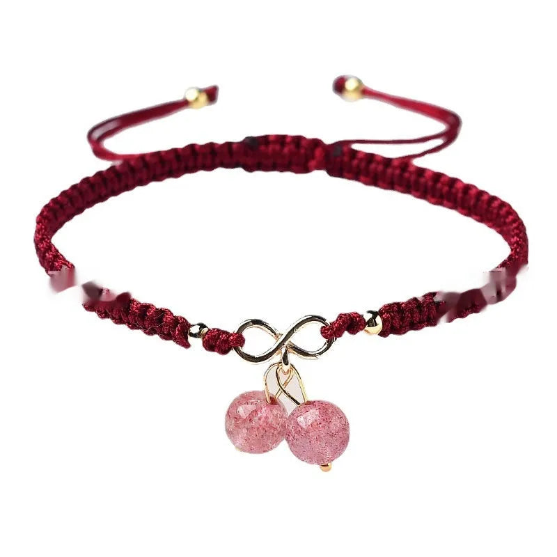 Women's natural strawberry quartz bracelet with a detailed cherry-shaped crystal charm.