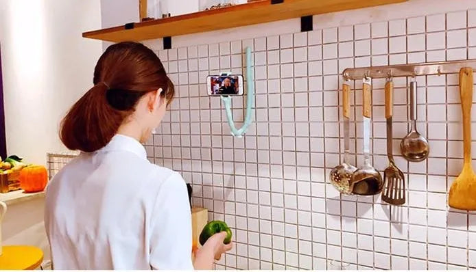 Flexible rubber phone holder with suction cup wrapped around bicycle handlebar