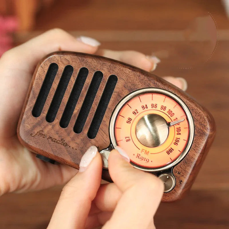 Retro wooden mini Bluetooth speaker in cherry or walnut finish showing compact size