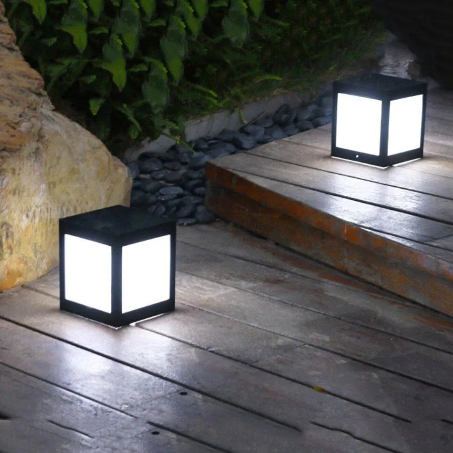 Set of solar-powered LED garden lights in different styles mounted on a garden wall and path