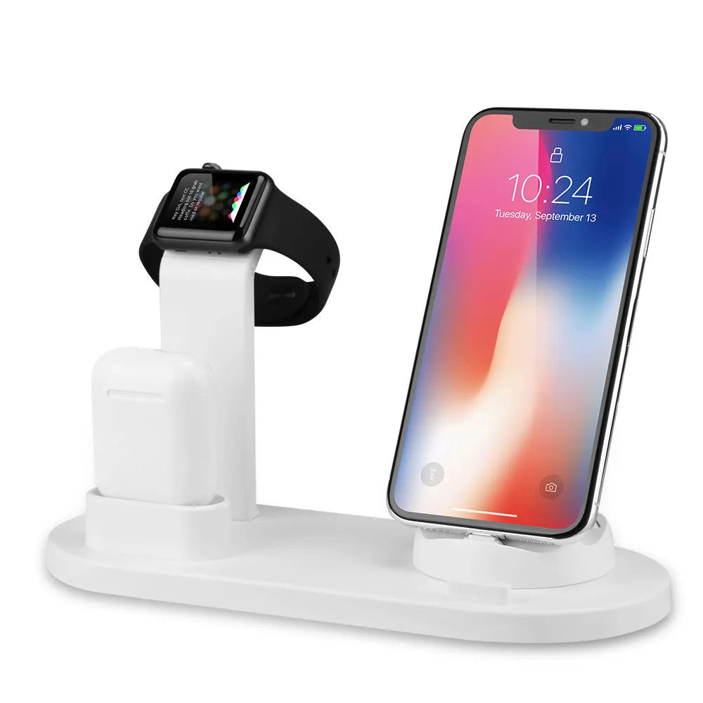 White three-port USB headphone charging stand holding wireless headphones and earbuds