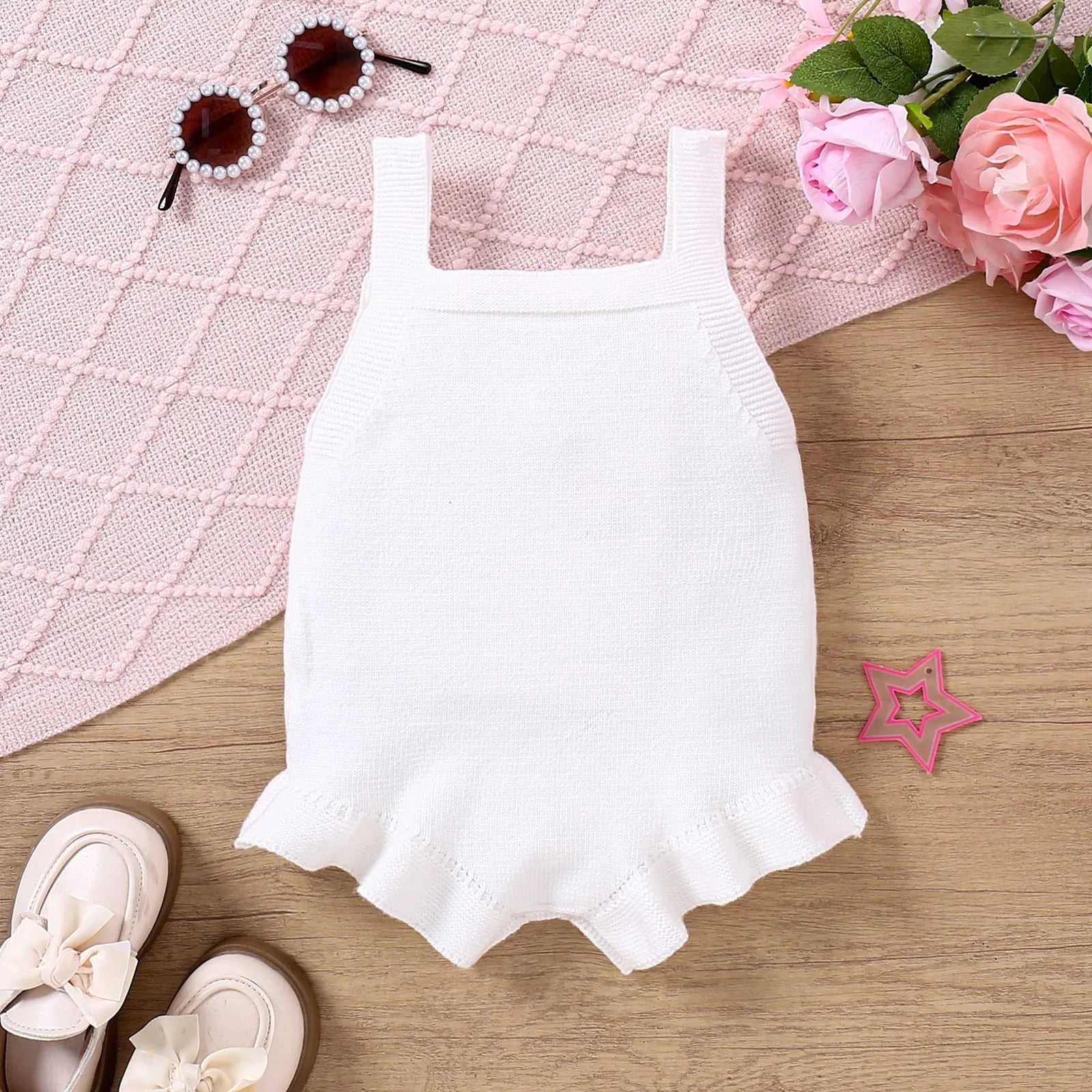 Baby girl sling romper in white with bow embroidery on wool blend fabric.