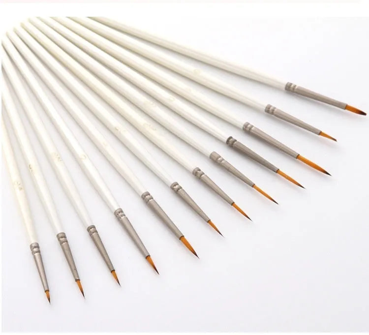 Set of 12 pearl white artists' brushes in a solid wood holder, sizes from 0 to 4/0 for watercolour and acrylic painting.