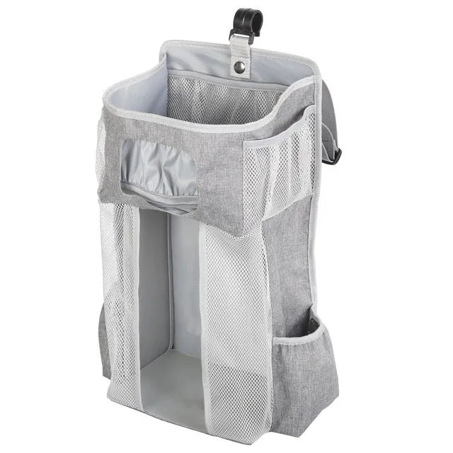 Grey attachable storage bag with diamond mesh panel and PP support plate, 44.6x23x16cm, hung on a white baby cot