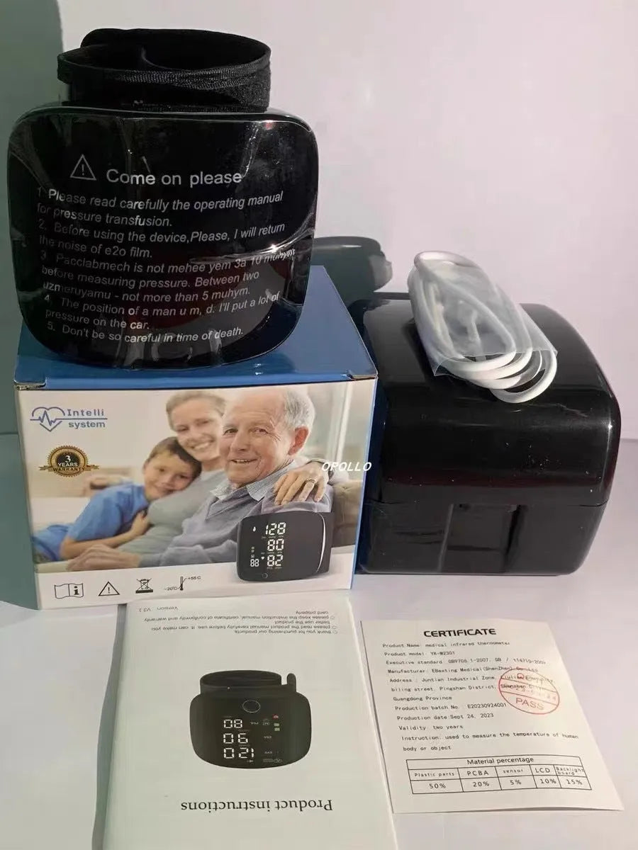 Black wrist blood pressure monitor with USB charging port on a table.
