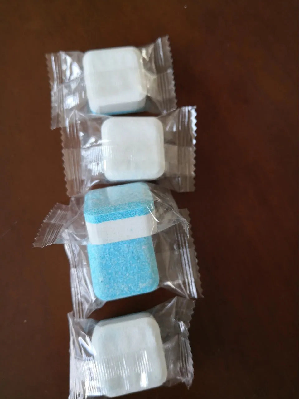 Blue and white washing machine tub bomb cleaner tablet in foil packaging 15g