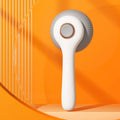 Blue and white dual-sided pet grooming brush for cats and dogs with self-cleaning feature.