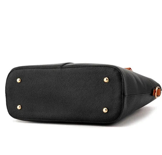Women's PU leather crossbody shoulder bag in Black with silver-tone clasp, worn over shoulder