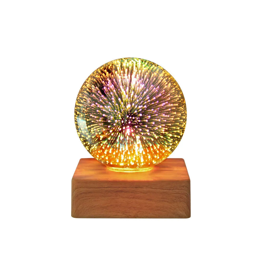 USB plug-in crystal ball night light displaying colourful firework pattern on a dark surface.