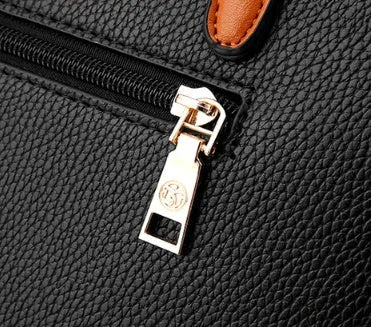 Women's PU leather crossbody shoulder bag in Black with silver-tone clasp, worn over shoulder
