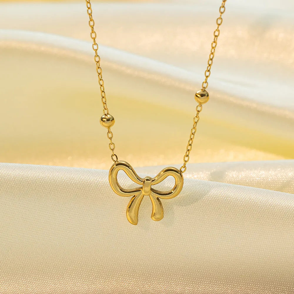 Gold electroplated bow necklace on titanium steel chain with adjustable 41-50cm length