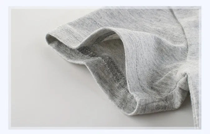 Grey children's cotton T-shirt laid flat, showing size tag with centimetre measurements.