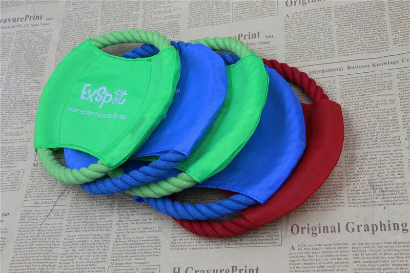 Canvas and rope dog flying disc toy with rain silk surface, 19cm diameter, on grass