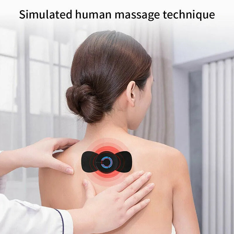 Black mini electric shoulder and neck massager with massage patch next to its 15cm long packaging.