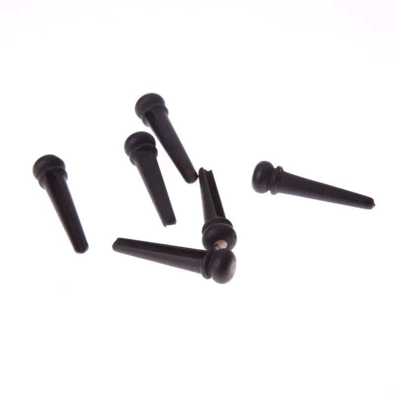 Six ebony guitar bridge pins with matt black finish and 5.3mm bayonet diameter