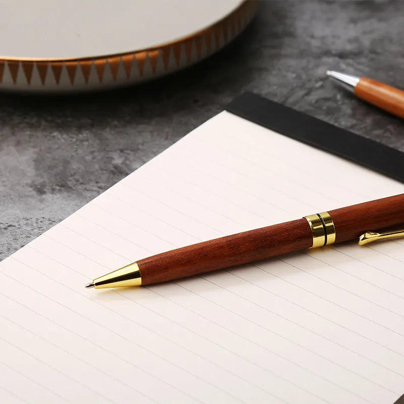 Wooden metal ballpoint pen with rosewood barrel on white background