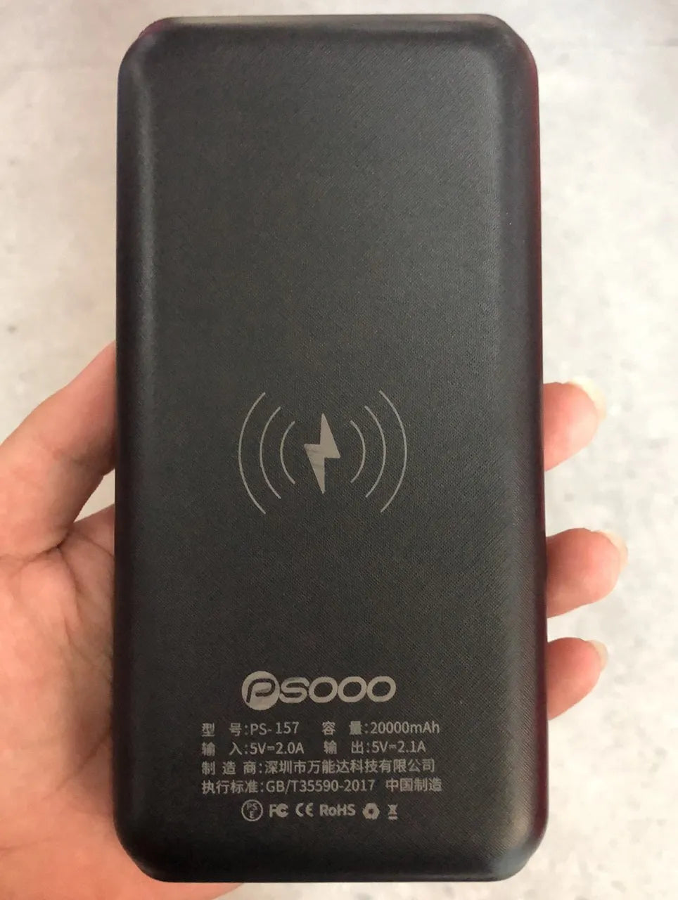 Wireless power bank with Qi charging showing three USB ports and LED flashlight in black-blue colour