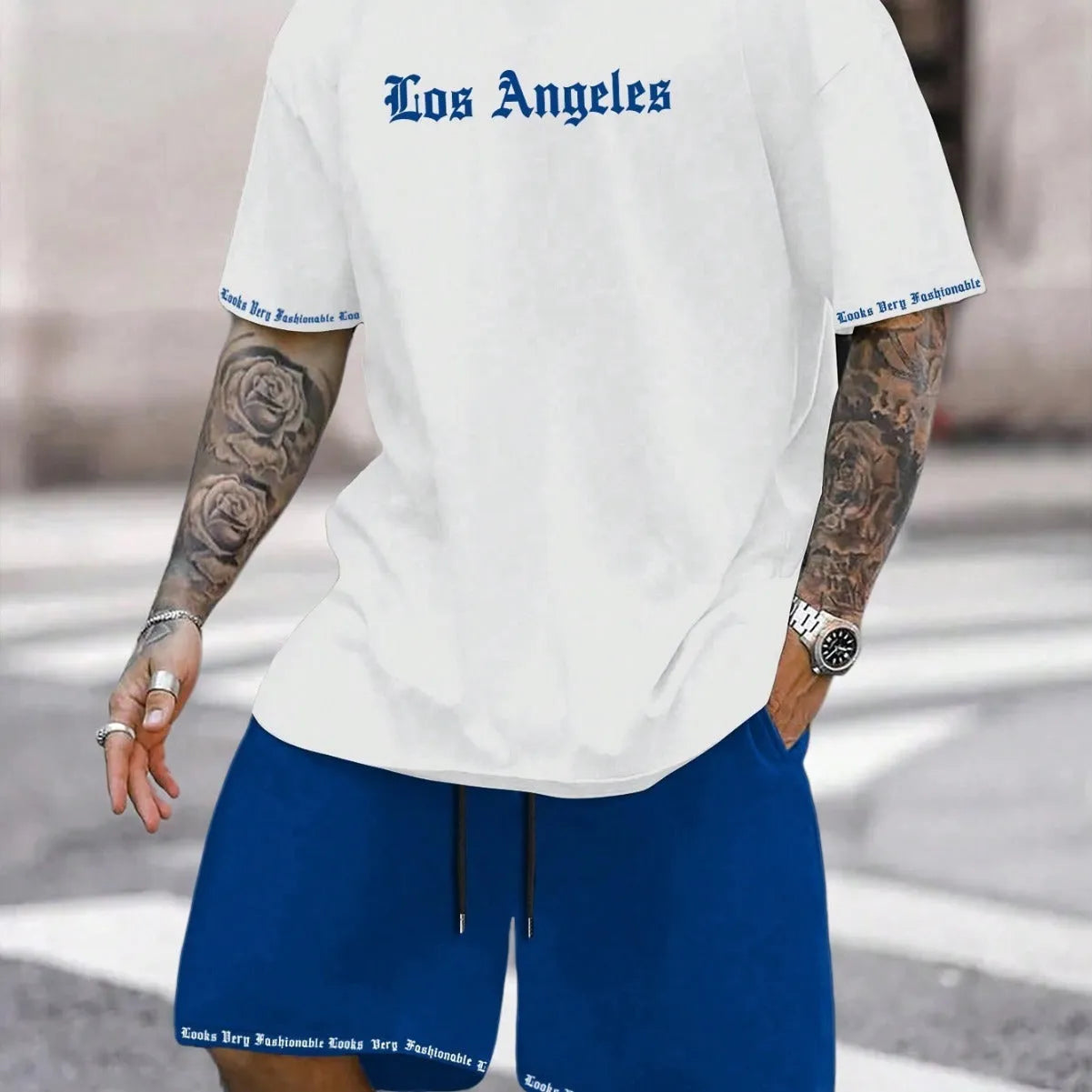 Man wearing a grey short-sleeved sports top and matching shorts from a quick-dry two-piece set.