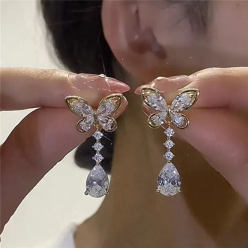 Women's zinc alloy bow stud earrings in platinum colour with electroplated finish, laid flat