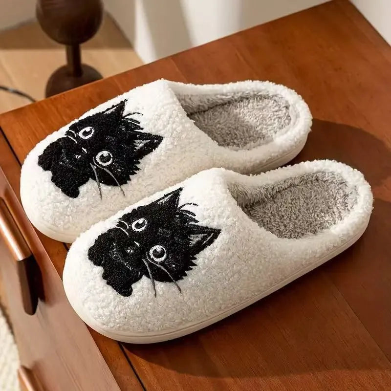 White plush slippers with a Black Beard Cat cartoon design on the toe.