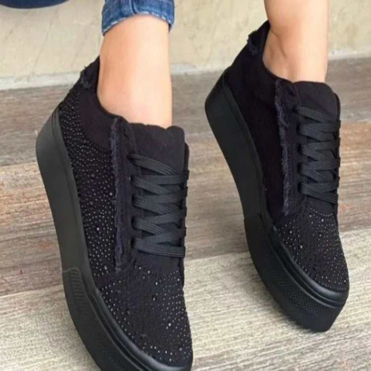 Women's plus size black casual sports shoes with rhinestones on the upper and a flat rubber sole.