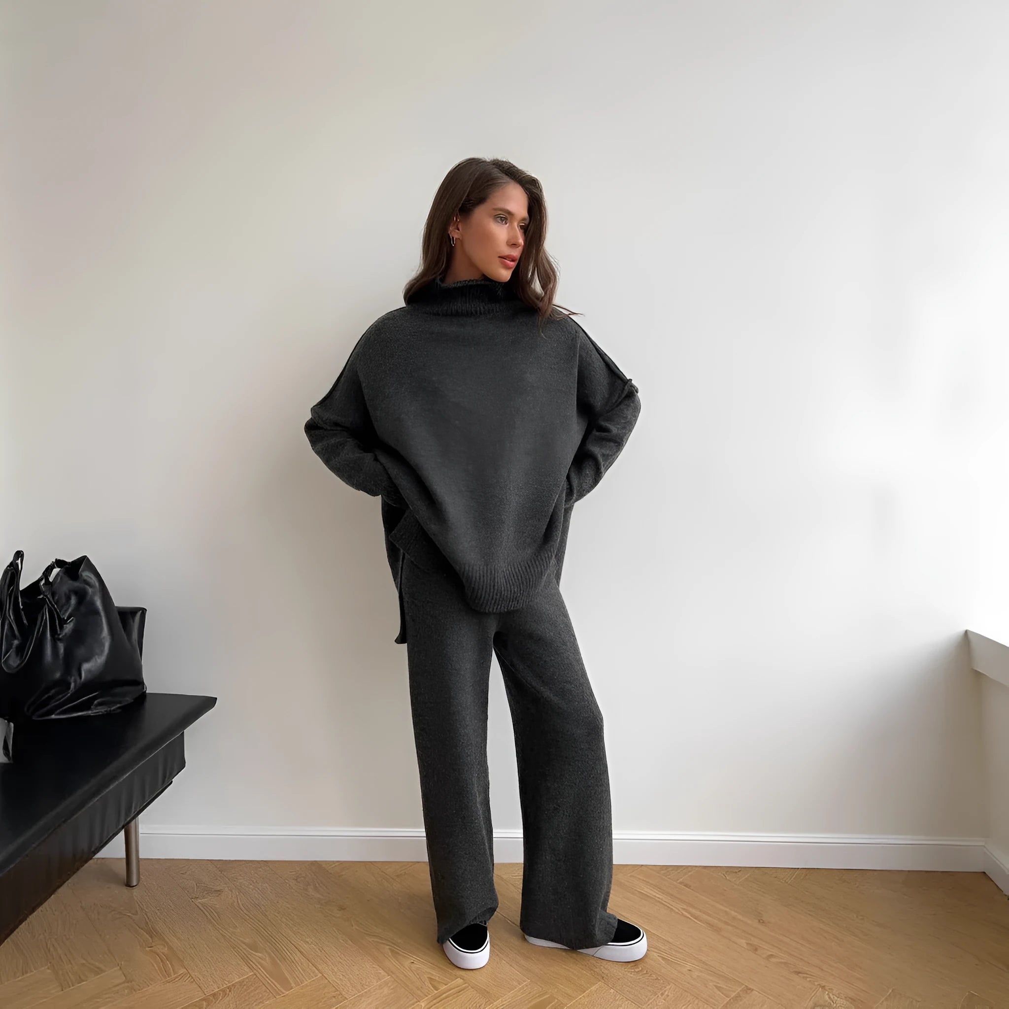 Dark grey women's knitted side-slit top and matching trousers set on a hanger