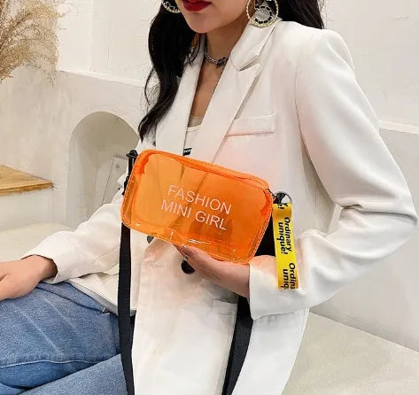 A transparent square jelly cross-body bag in a choice of colours, shown with an adjustable strap and a mobile phone inside.