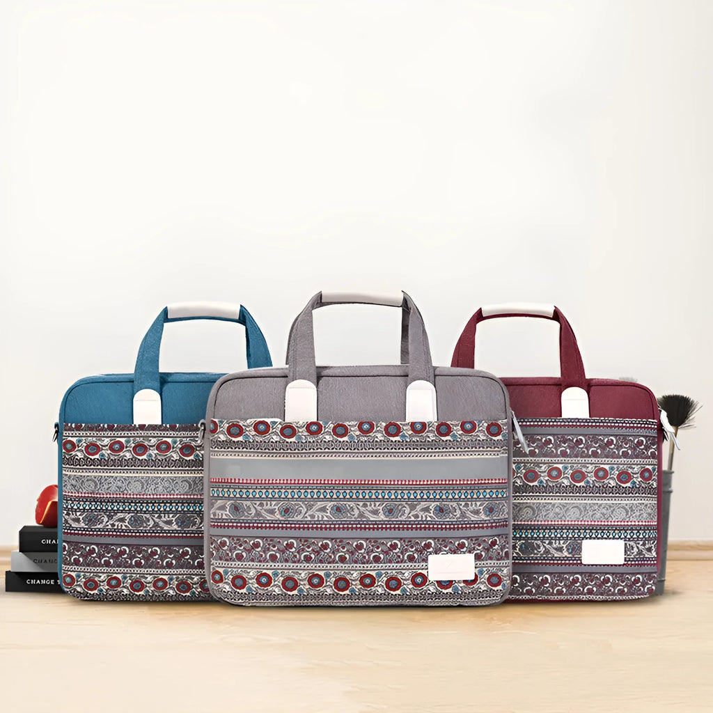 Ethnic style canvas laptop bag in lake blue with zippered front pocket on a table