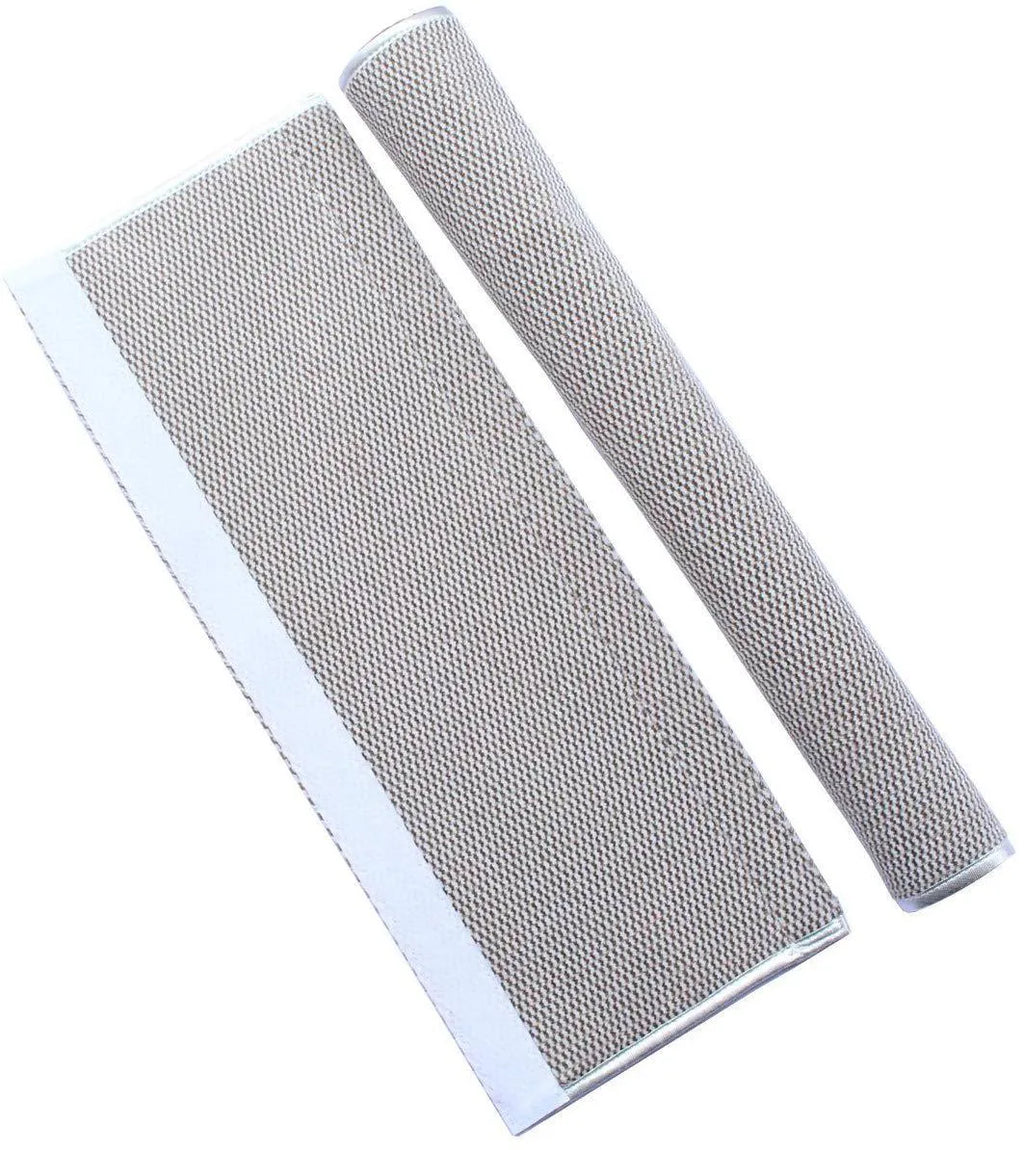 Grey solar wall lamp with LED light in garden setting showing warm light effect