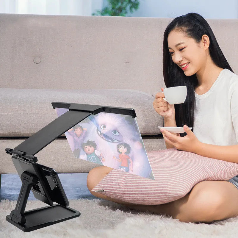 Black L20 split mobile phone screen magnifier with acrylic lens and separate ABS support bracket on a table.