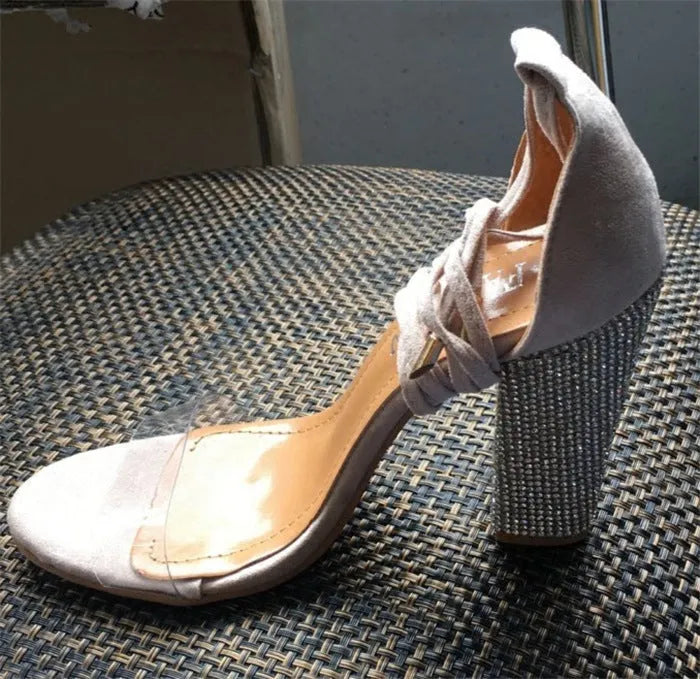 Black and gold pointed-toe high heels for women with plastic construction.