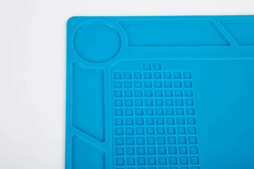 Blue silicone watch repair table mat on workbench for non-slip timepiece servicing