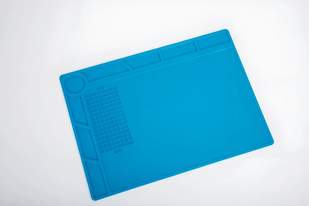 Blue silicone watch repair table mat on workbench for non-slip timepiece servicing