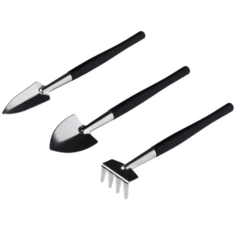 Black plastic and metal mini garden tool set with 16 pieces including tweezers, shovels, brushes, bottles, and a square work cushion for succulent care.