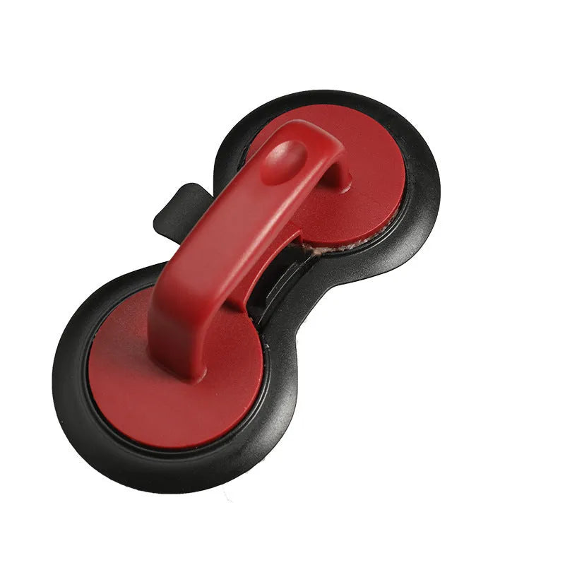 Black and red round burger press with non-stick surface and oil paper liners.